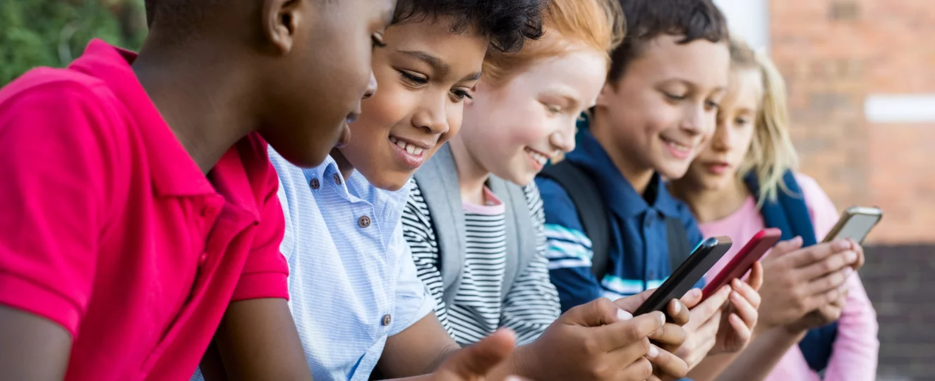 Kids looking at cell phone