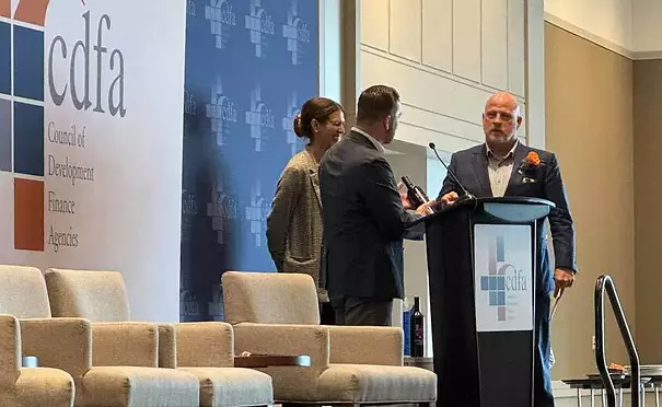 Price Finley stands at the podium to receive his award from the CDFA.