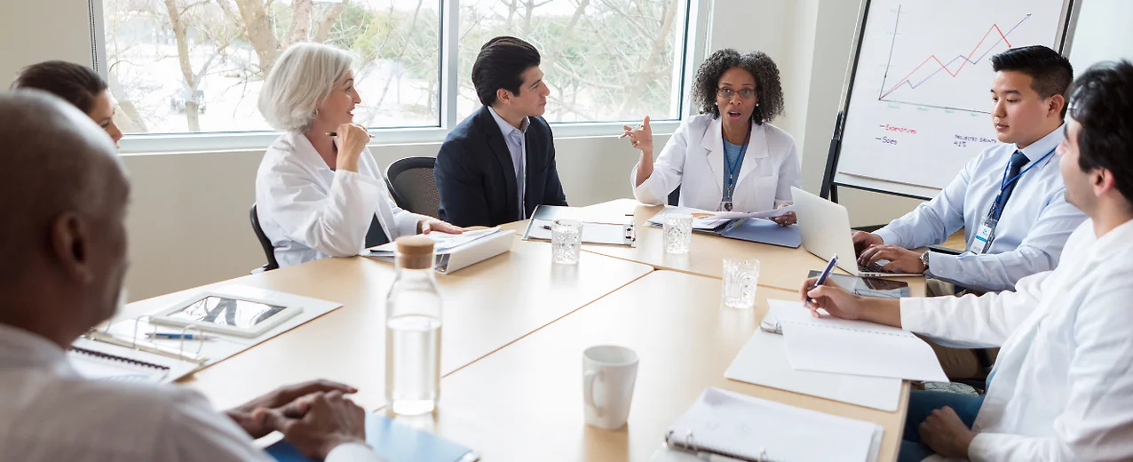 Doctor speaks to colleagues during medical meeting