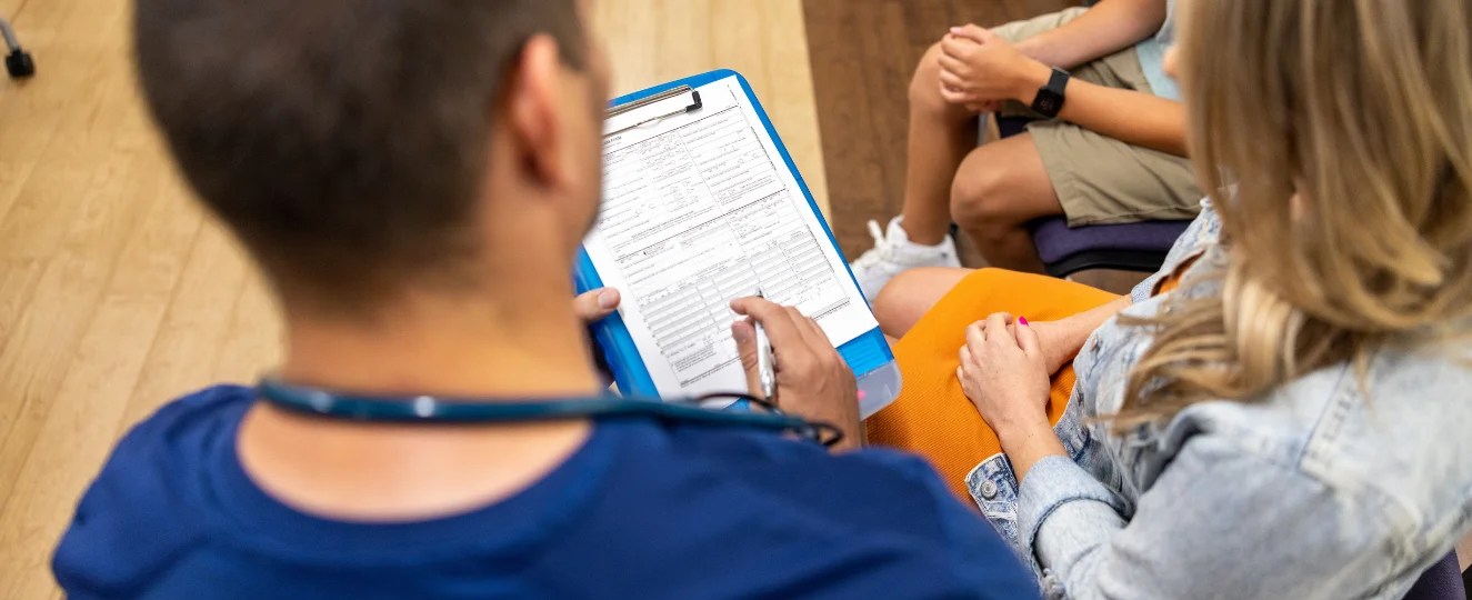 Nurse receptionist explains paperwork in lobby