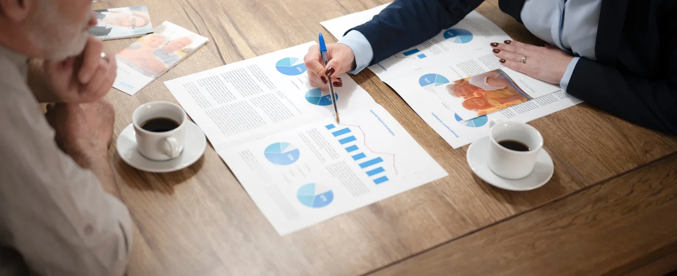 Advisor explaining document to man