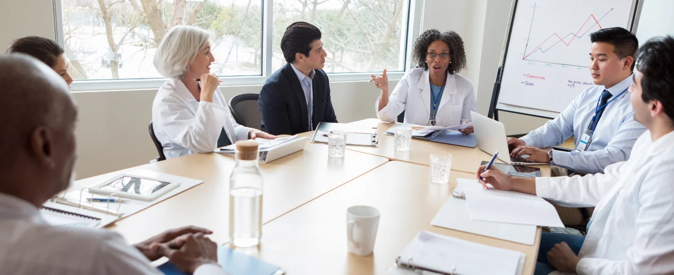 Doctor speaks to colleagues during medical meeting