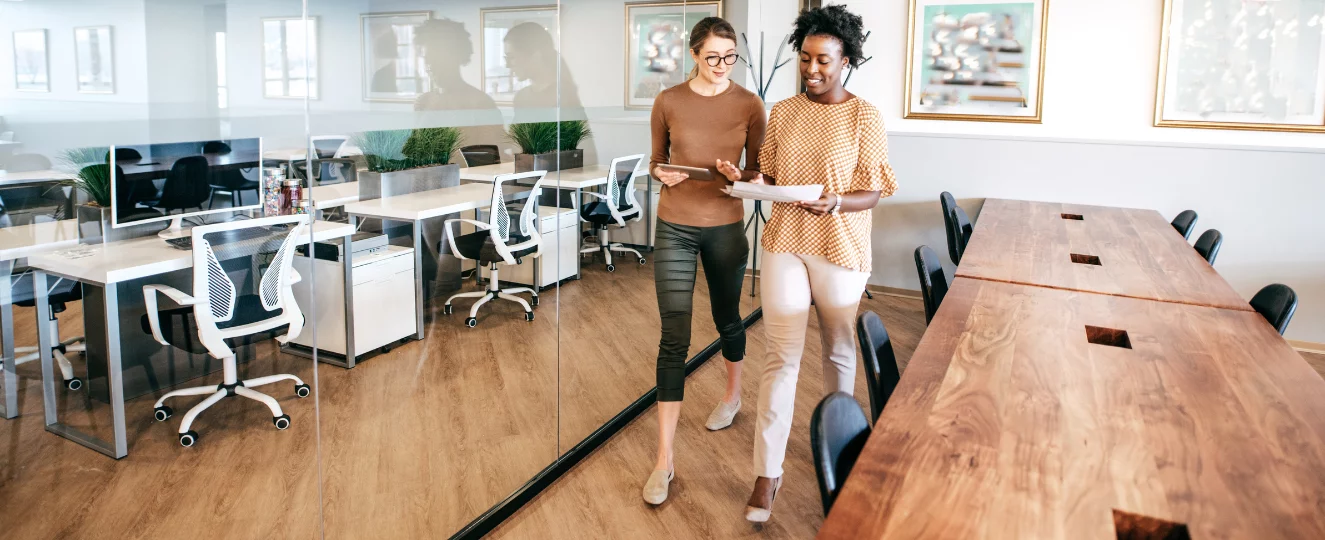 People walking and talking in an office setting