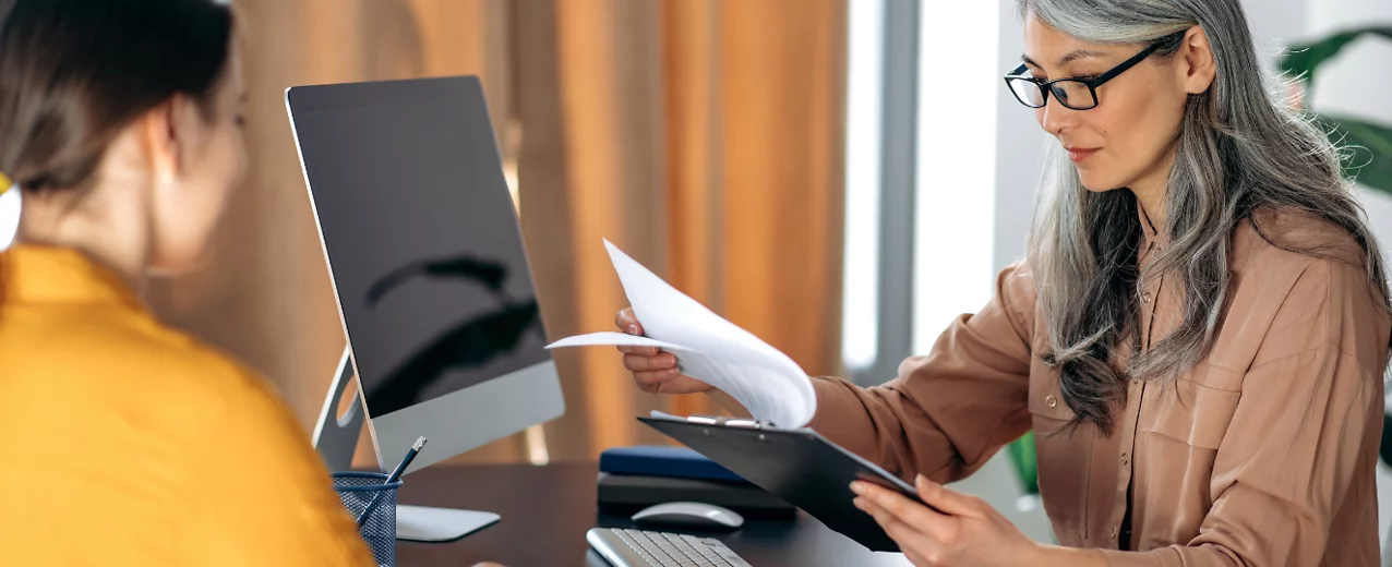 Two people discussing benefits information