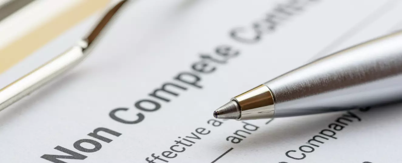 Blue ballpoint pen on a non compete contract
