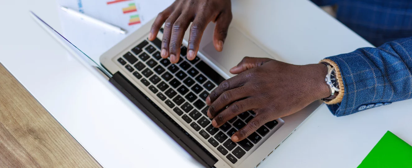 Person typing on computer and looking at data